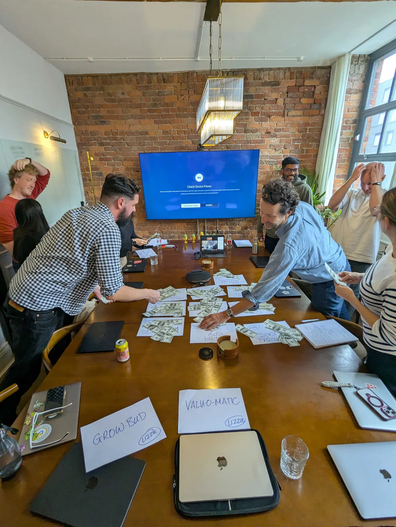 The team working through a prioritisation exercise round a table in Manchester